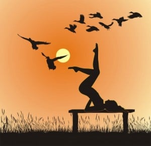 Woman doing yoga at Sunset