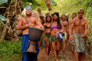 a group of people wearing tribal clothes in a tropical forest