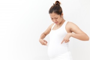 "Pregnant Woman Touching Her Belly" by Jomphong