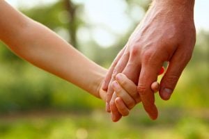 parent holding child's hands
