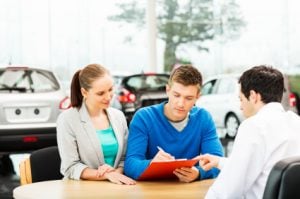 group of people negotiating car price