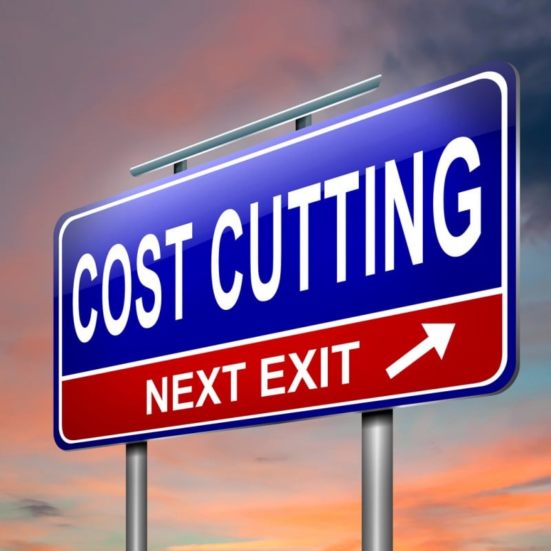 sign saying cost cutting, next exit to show ways to be wealthy in your 20s
