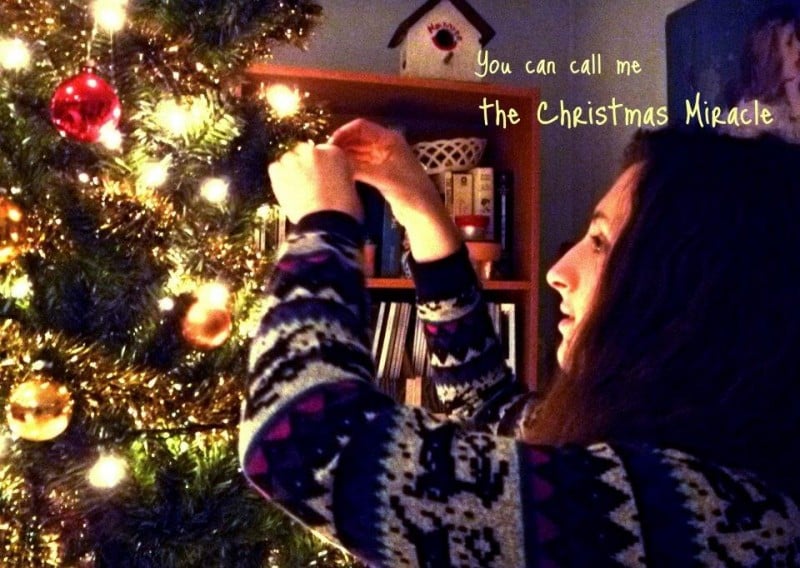 woman decorating a christmas tree