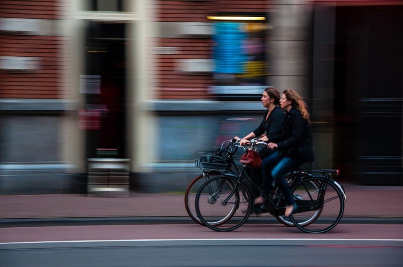 women cycling through town