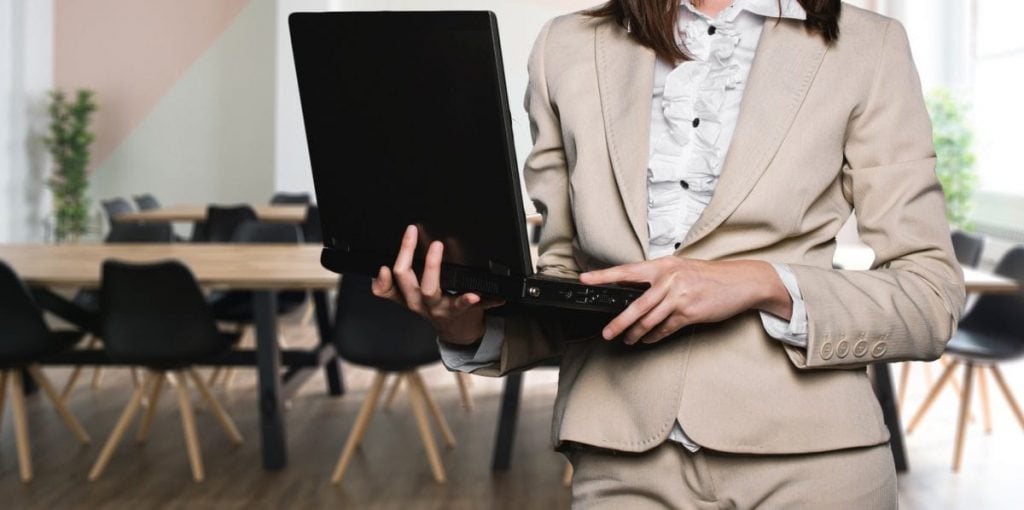 businesswoman holding laptop