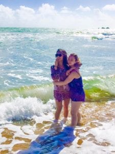 two women standing in ocean with body confidence miss millennia magazine
