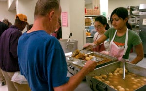 woman serving food at soup kitchen