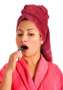 Woman Brushing Teeth to curb sweet tooth