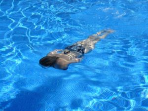 girl swimming in swimming pool