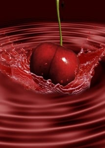 cherry being dropped into tart cherry juice food to be beautiful