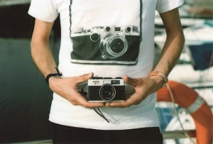 guy wearing a camera tshirt and holding a camera