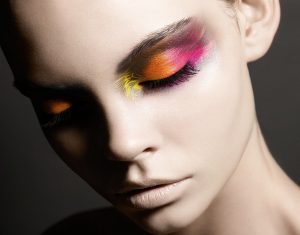 Girl wearing pink, orange, and yellow eye makeup