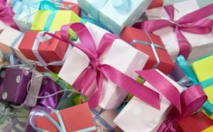 gifts with different colored wrapping and bows
