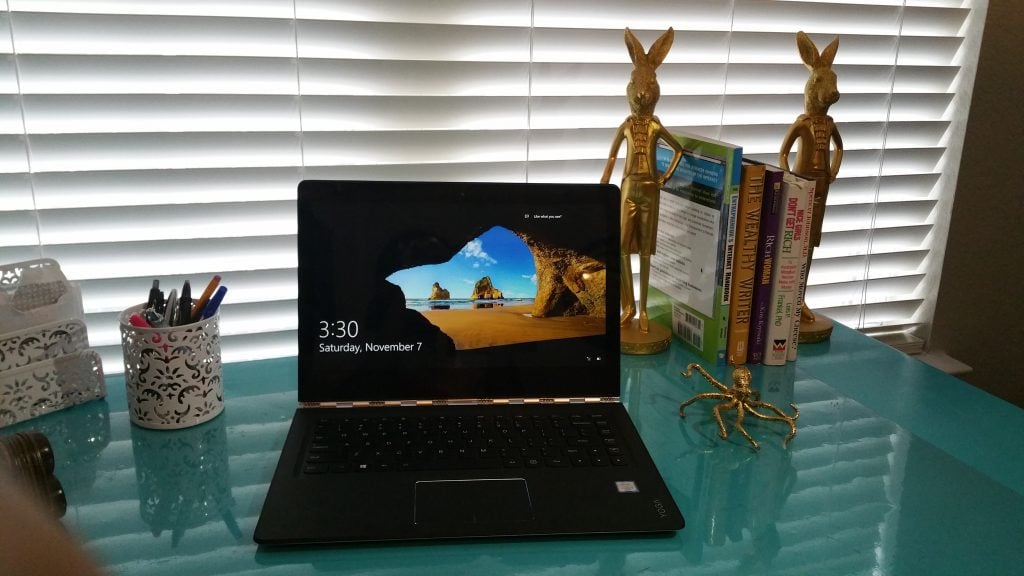 A Lenovo Yoga 2in1 laptop sitting on a desk