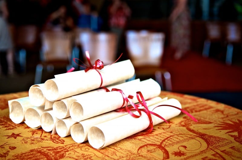 diplomas stacked on table