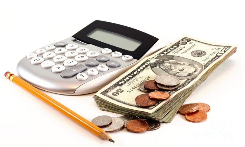 calculator and money and pencil to manage personal finances