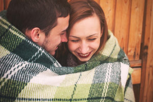 couple hugging in a blanket