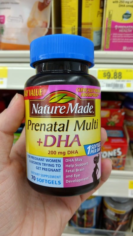 hand holding Nature Made prenatal vitamins to maintain a beauty regime