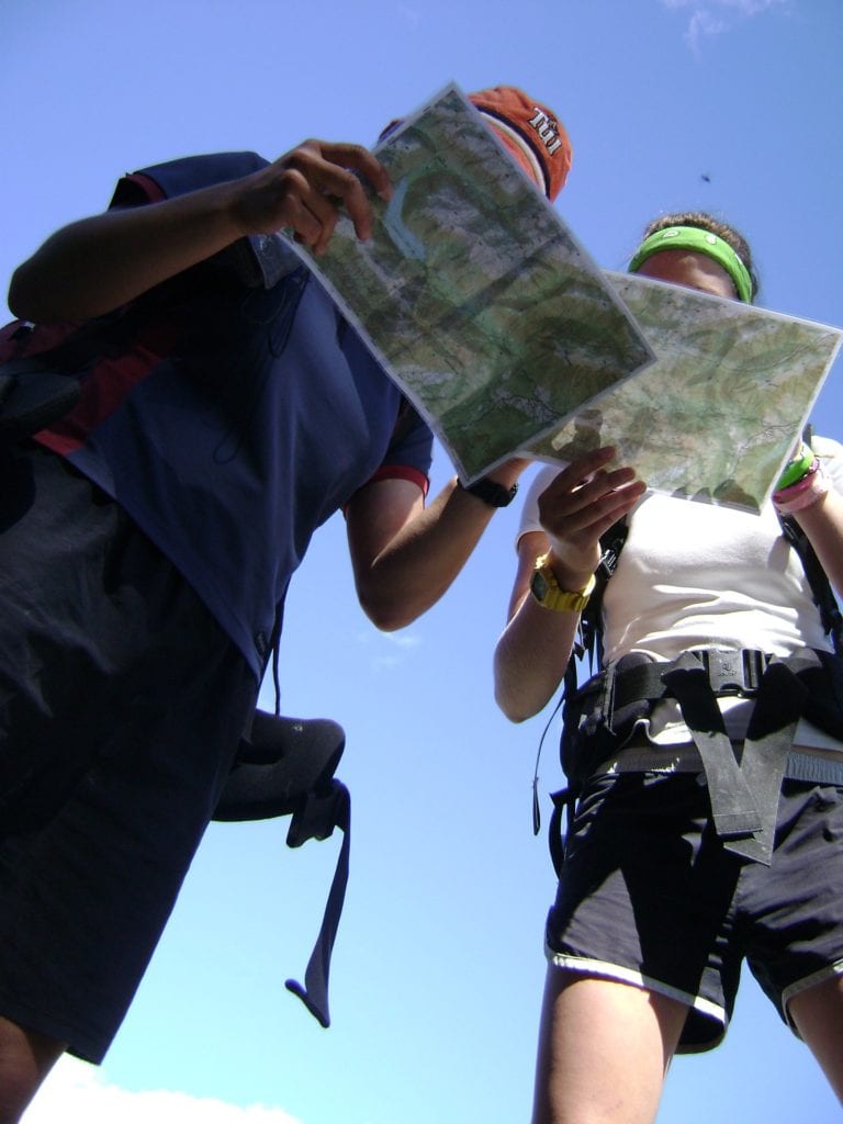 Two women reading maps