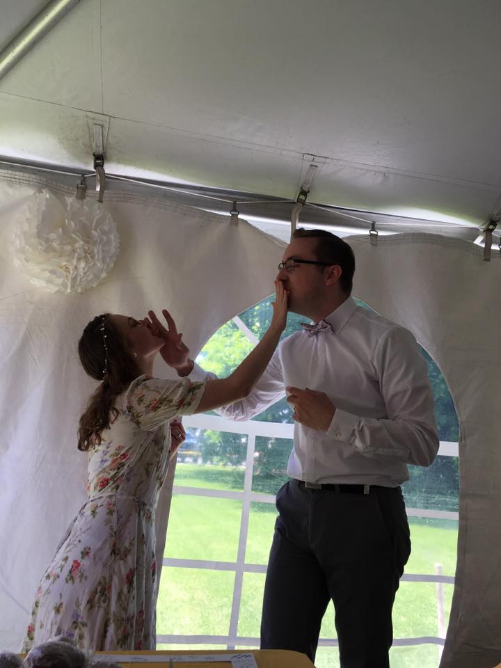 man and woman feeding each other at wedding