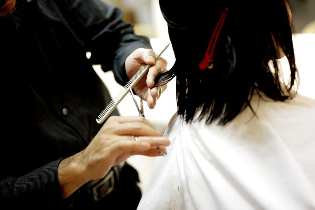 man cutting woman's hair