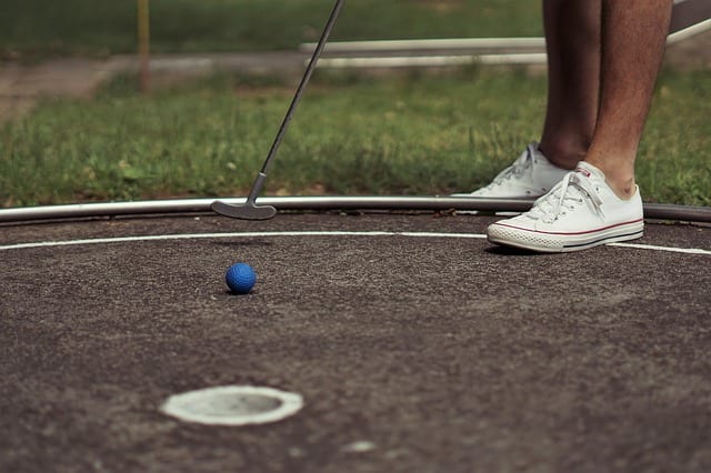 person playing mini golf