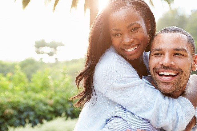 two people hugging and smiling