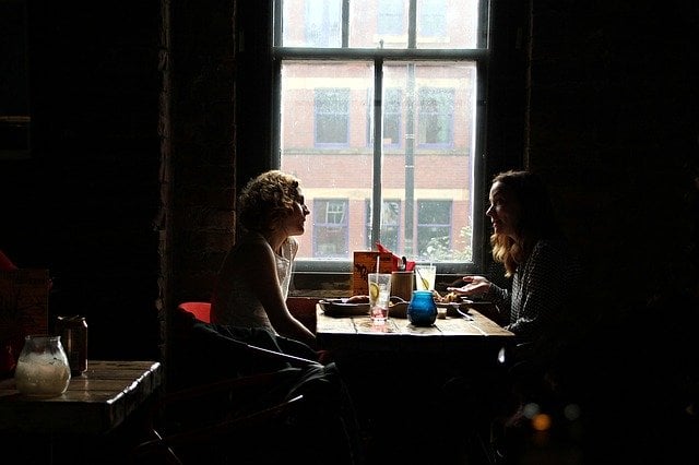 two people sitting at a restaurant