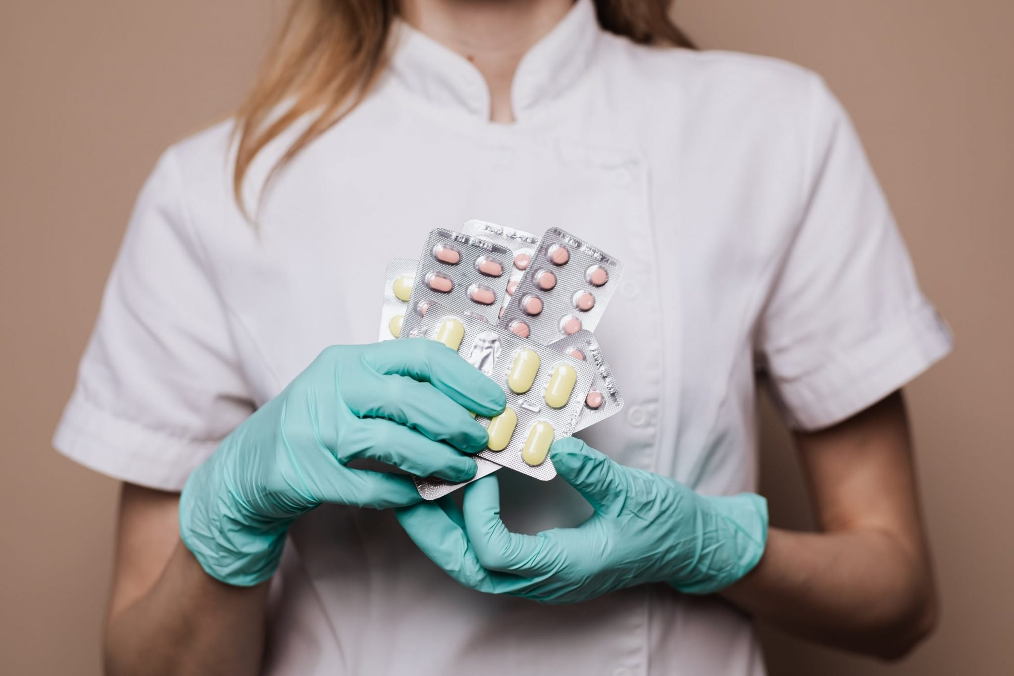 healthcare worker holding pills