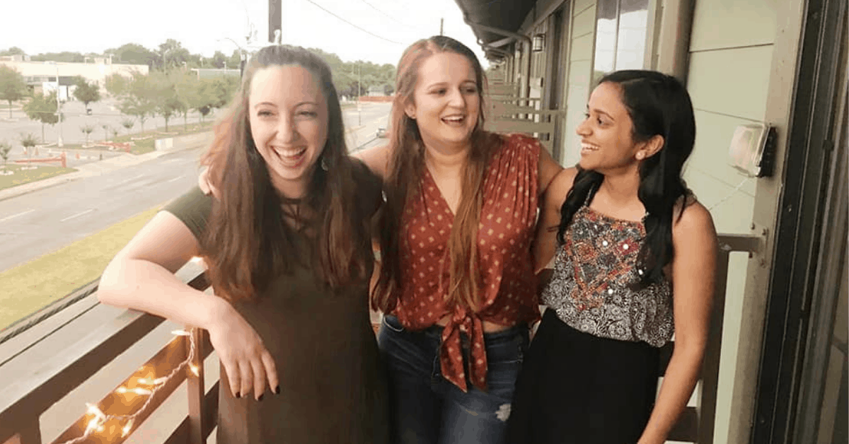three friends laughing outside