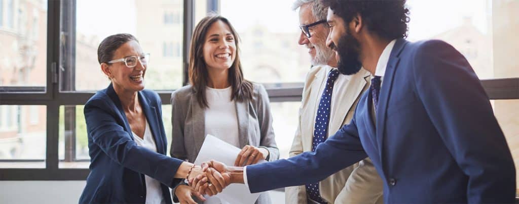 A group of people shaking hands 