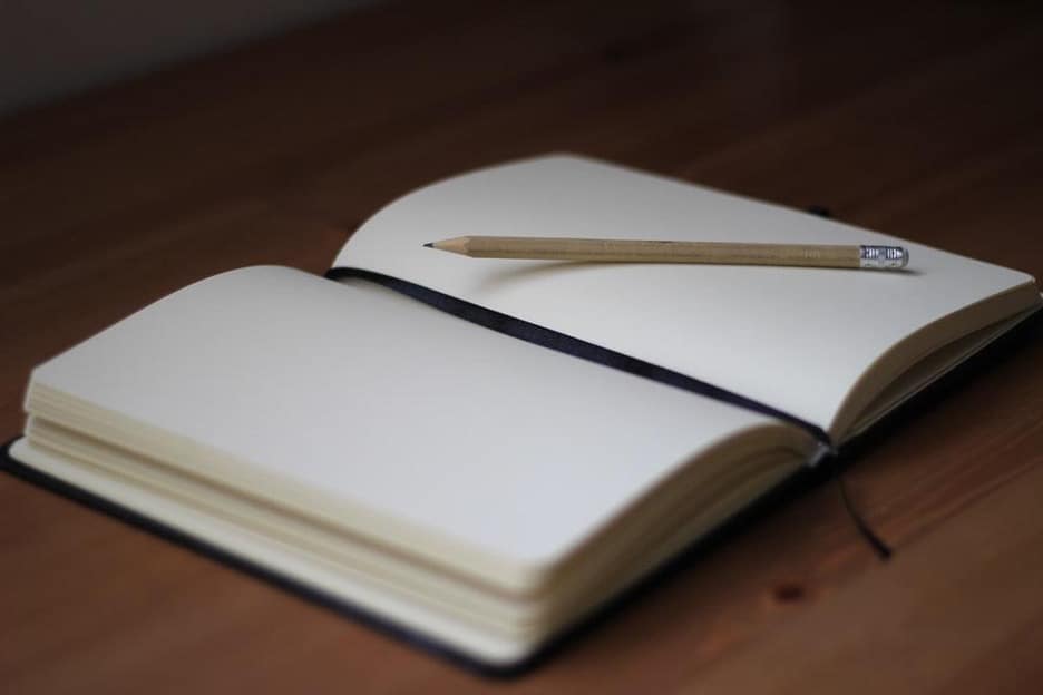 An open journal and pencil