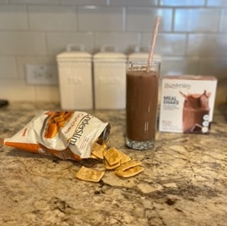 A mocha cream shake and cheddar crunchers on a kitchen island 