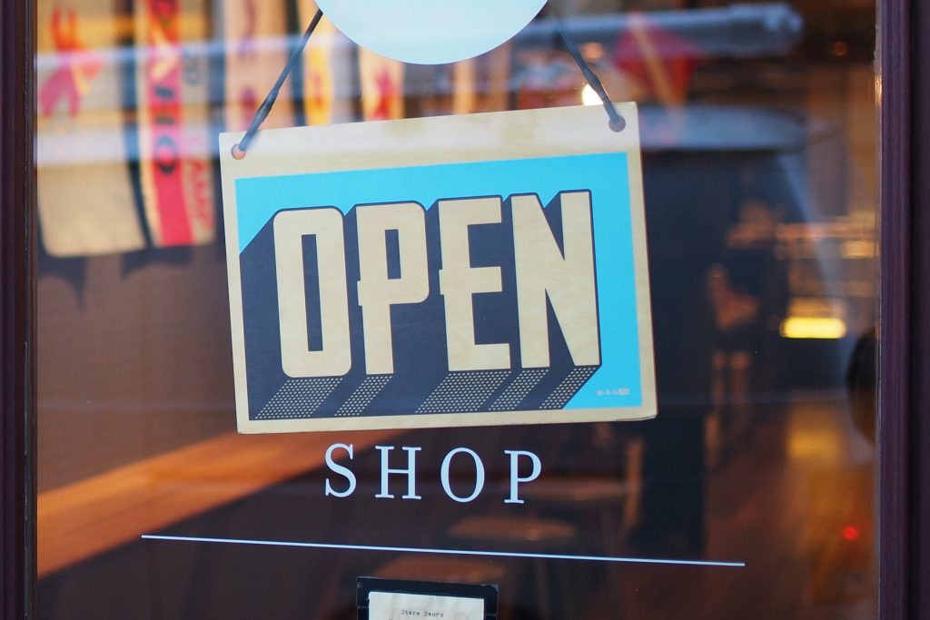 An open sign on the door of a shop