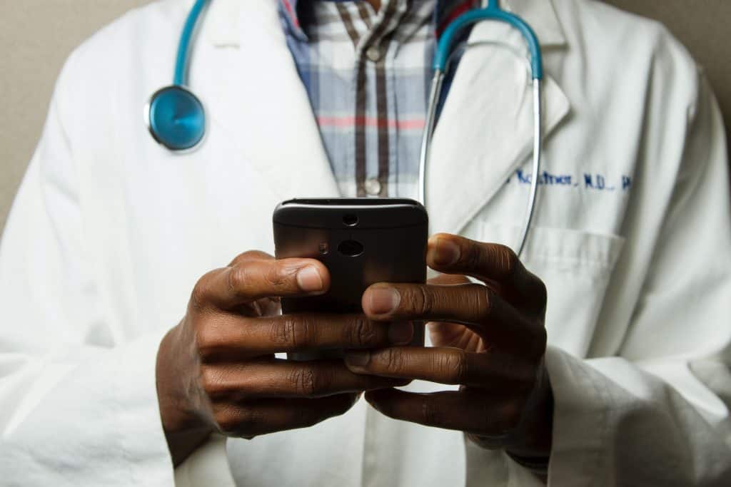 A doctor working on his phone