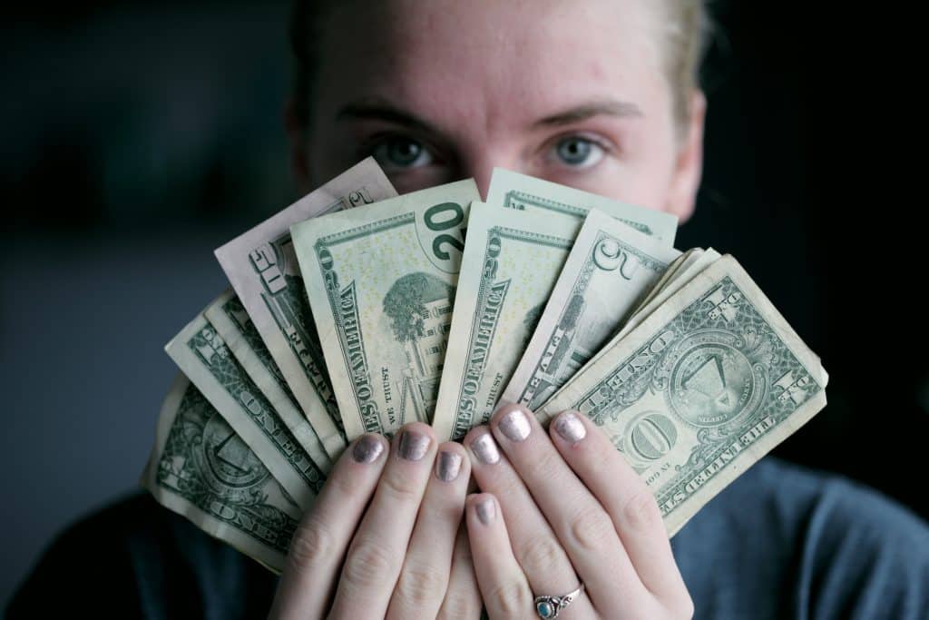 A person holding fanned out cash
